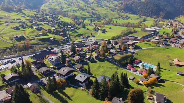 Aerial view of Grindelwald Grund railway station and the alpine village in autumn. Grindelwald, Canton of Bern, Switzerland.