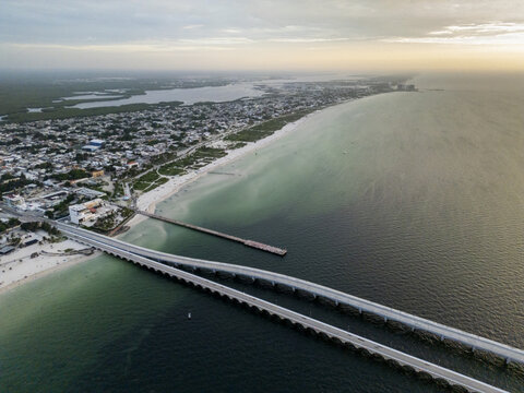 Aerial view of Puerto Progreso featuring the long pier extending into the Gulf of Mexico, sandy beaches, and the coastal town infrastructure in Progreso, Yucatan, Mexico.