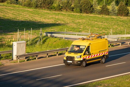 Highway Service Van Driving at Golden Hour, Concept of Road Maintenance Operations and Infrastructure Support Services