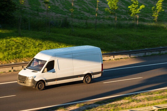 White Cargo Delivery Van Traveling on Expressway, Concept of Last Mile Logistics and Commercial Transportation
