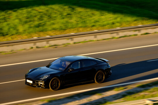 Luxury Black Sport Sedan Cruising on Open Highway, Concept of Premium Mobility and High Performance Driving
