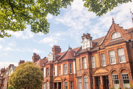 LONDON - red brick terraced houses on residential street with trees