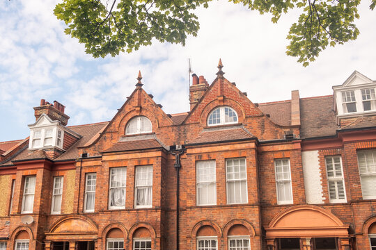 LONDON - red brick terraced houses on residential street with trees