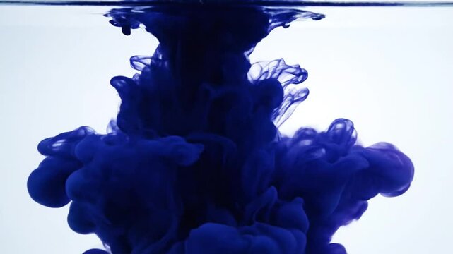 Blue ink cloud suspended in clear water on white.