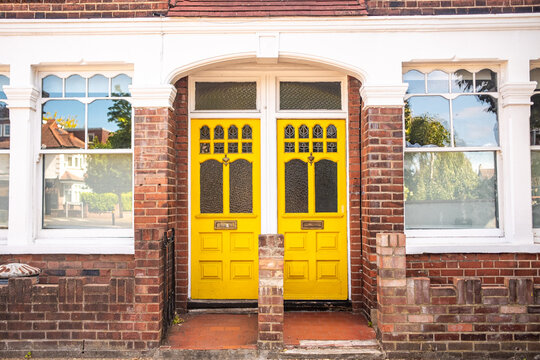 LONDON - bright yellow doors on period terraced house