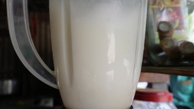 Blending creamy milkshake with fresh ingredients