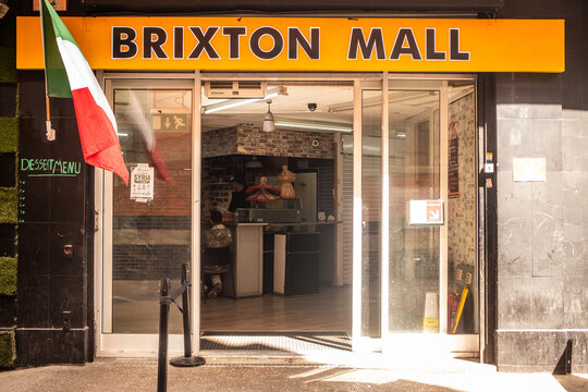 LONDON - Brixton Mall &ndash; Entrance to Brixton Mall with Italian flag and food counter inside.