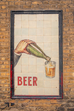 LONDON - vintage beer ghost sign on brick wall