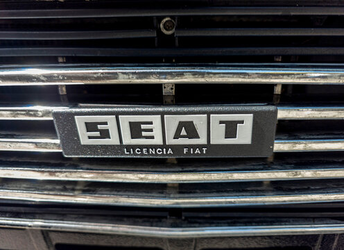 TAVERNES BLANQUES, SPAIN - JUNE 14, 2026.Detailed macro view of a vintage SEAT Licencia Fiat emblem on a classic car grille from the past
