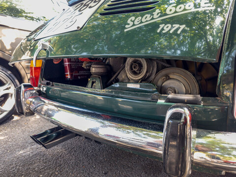 TAVERNES BLANQUES, SPAIN - JUNE 14, 2026.Close up view of shiny chrome bumper and exhaust tip of classic SEAT E retro car with engine cover open in parking area