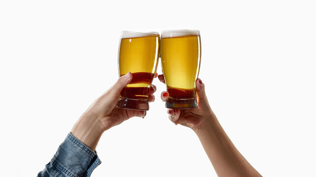 Hands raising two beer glasses for cheers on white background. Concept of beer party, friendship, success toast, afterwork leisure, Oktoberfest poster and bar promotion.
