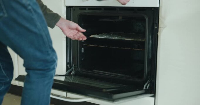 Caucasian man make potato pie. Single male is cooking at kitchen at home. 4K 10-bit