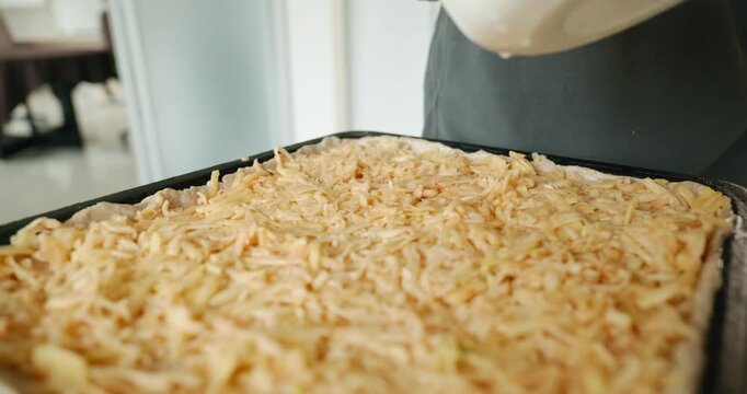 Caucasian man make potato pie. Single male is cooking at kitchen at home. 4K 10-bit