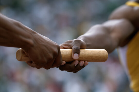 Relay team exchanges baton during race event