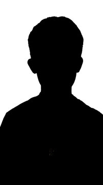Black silhouette of a small boy standing against a white background
