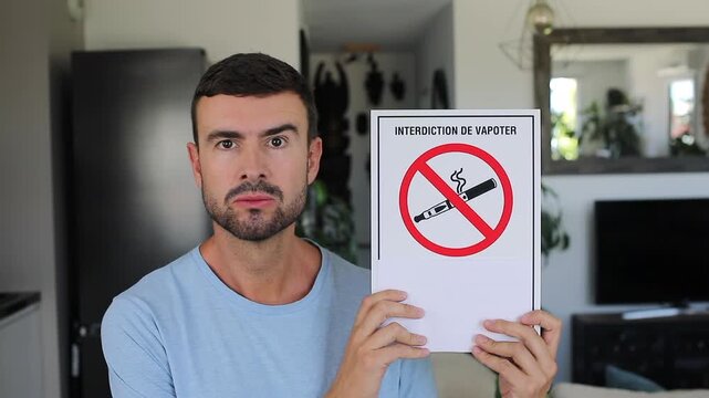Man Holding French No Vaping Prohibition Sign