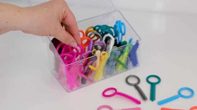 Colorful orthodontic elastics and ligatures arranged on table for dental treatment and braces care