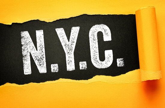 N.Y.C. text on torn paper background with bold distressed font. Urban typography symbolizing New York City, travel, culture, and iconic modern metropolitan lifestyle branding