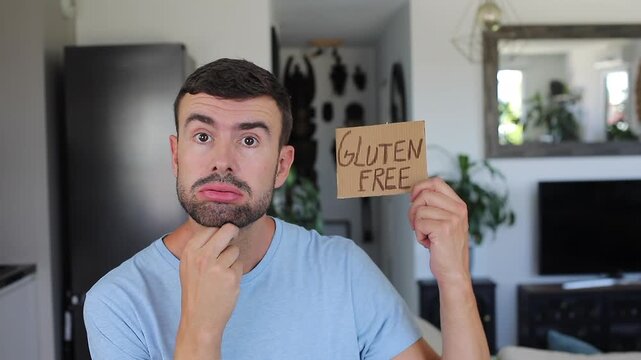 Frustrated Celiac Man Holding Handwritten Gluten Free Sign Showing Diet Anxiety
