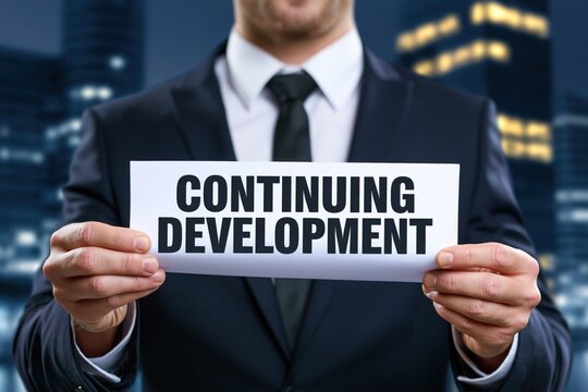 Businessman in dark suit holding white paper with continuing development concept