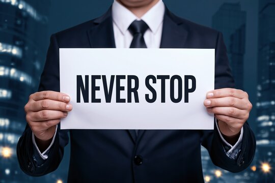 Corporate Businessman Holding Never Stop Paper Message