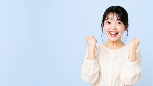 Successful Japanese woman victory reaction with copy space