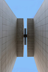 Obraz premium Modern architecture walls creating geometric passageway viewing blue sky