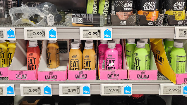 Colorful protein drinks and supplements displayed on supermarket shelf