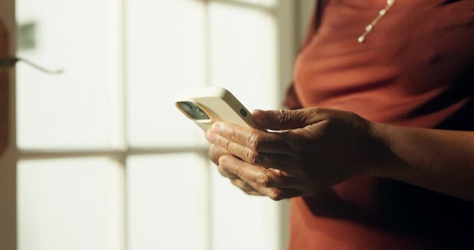 Texting, online and hands with phone in home, chatting or communication with contact on social media. Typing, message and person with mobile, internet connection and networking with tech in house