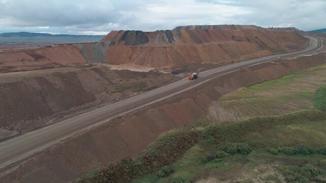 Aerial panoramic view of a coal mining quarry. Heavy mining machinery and dump trucks in a quarry.