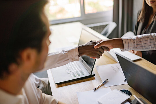 A meaningful handshake between two professionals signifies a successful business agreement in a bright and modern office environment, fostering collaboration and teamwork