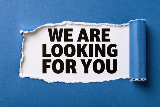 We are looking for you written on white paper under torn blue background