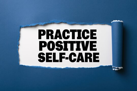 Practice positive self-care phrase under torn dark blue paper