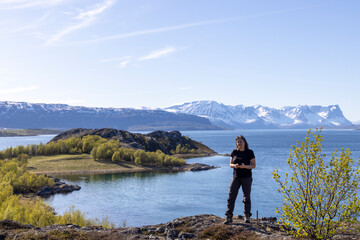 Fototapeta premium Woman on Kvaenangen fjord in northern Norway, Troms county