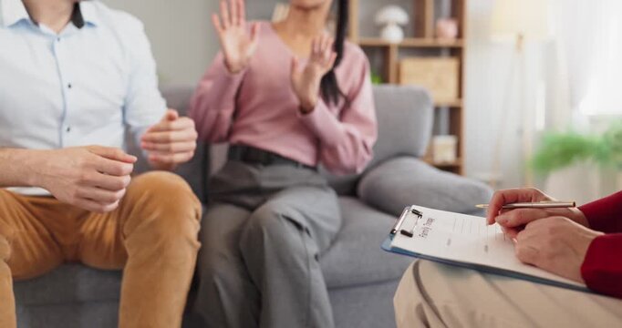 Couple with therapist in counseling session. Man and woman share concerns as a professional takes notes in a calm office environment to guide dialogue. Clear couple therapy concept image.