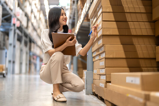 Inventory checklist, smiling asian woman using clipboard and pen for quality control, Product inspection, retail logistics, supply chain management, commercial business and merchandise distribution
