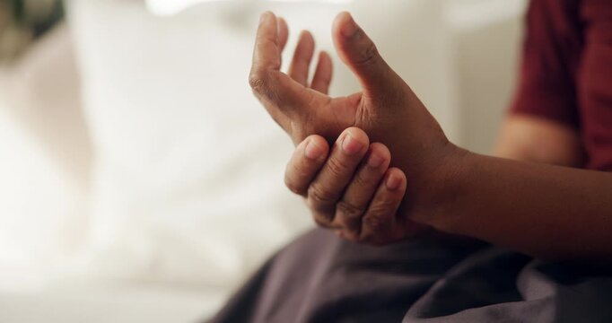 Hands, pain and woman at house with discomfort, inflammation and symptoms of osteoarthritis. Massage, female person and living room with muscle stiffness, poor circulation issues and chronic numbness