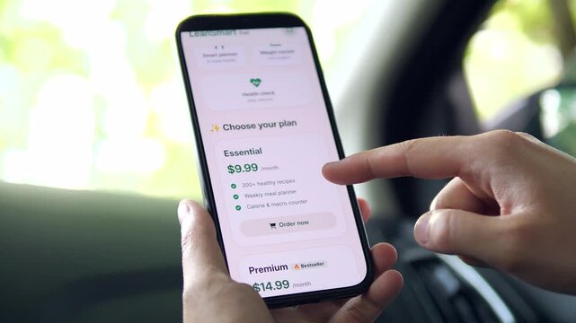 Finger tapping the Order now button for the Premium plan. The list of exclusive perks includes live coaching and a personalized detox plan. Perfect for app monetization, premium features, and added