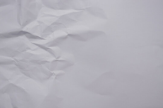 soft white linen texture paper background with a crumpled section transitioning into a smooth clean surface