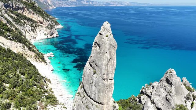 4K drone footage of Goloritz&egrave; Beach on the Baunei coast, Gulf of Orosei, Sardinia. Crystal-clear turquoise waters, white limestone cliffs, and one of Italy&rsquo;s most iconic seascapes