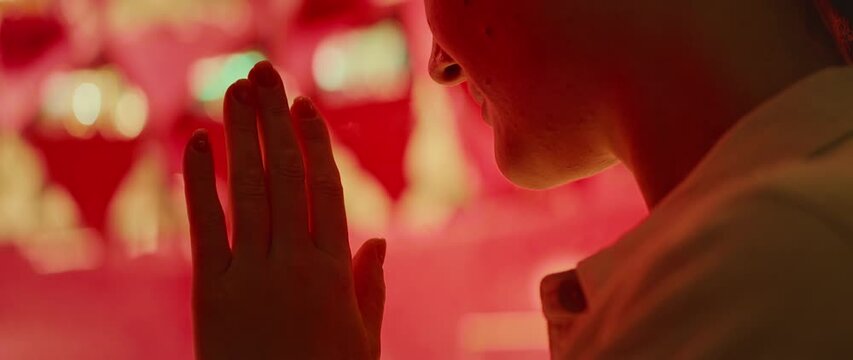 Woman leaned against the shop window, her hands on the glass, mesmerized luxury items inside