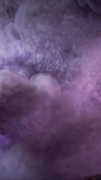 Vertical video: Forming as pale purple cloud entering tank, dye plume curling and settling on sand