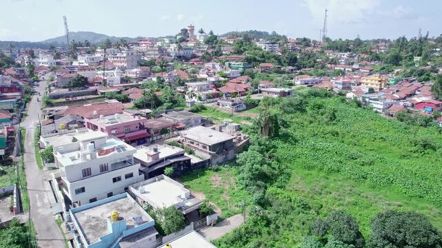 A drone view of madikeri rural old homes buildings and scenic countryside landscape surroundings