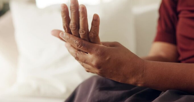 Hands, pain and woman in home with discomfort, inflammation and symptoms of osteoarthritis. Massage, person or house with muscle stiffness, poor circulation issues and chronic numbness in living room