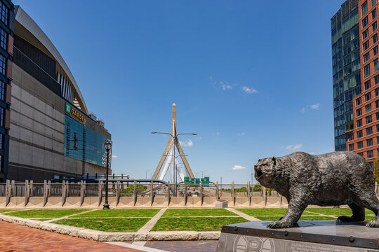 Boston, MA, US-May 26, 2026: View of the Zakim Bridge next to Boston Garden sports arena with a statue of a bear or Boston Bruin in foreground.
