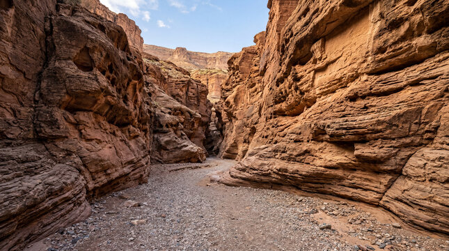 Deep canyon ravine carved by historic flash floods in an arid desert sand environment landscape
