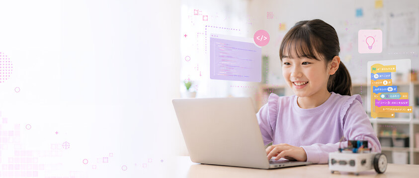 ノートパソコンでプログラミングを学ぶ小学生の女の子