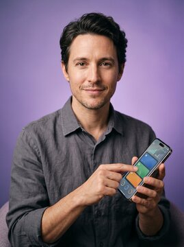Person holding smartphone with virtual cards on screen, confident and in control