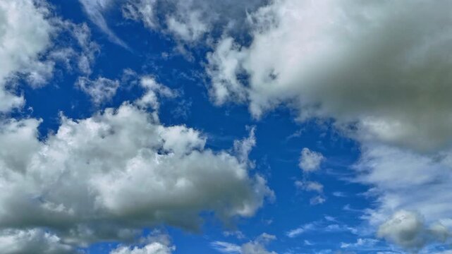 Dramatic Cloud Hyperlapse with gigantic clusters of clouds as two layers twirl in different directions.