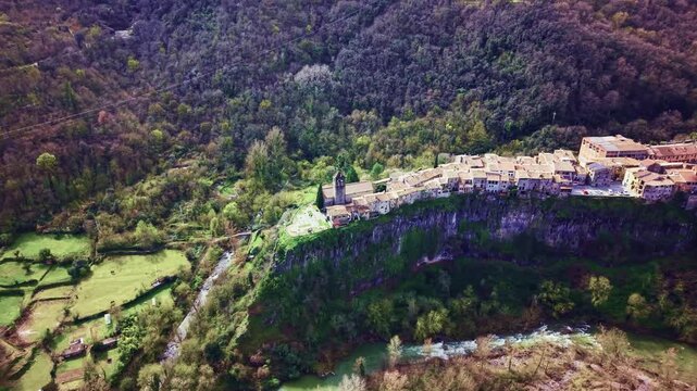 Historic church and cliff edge village of Castellfollit de la Roca from drone
